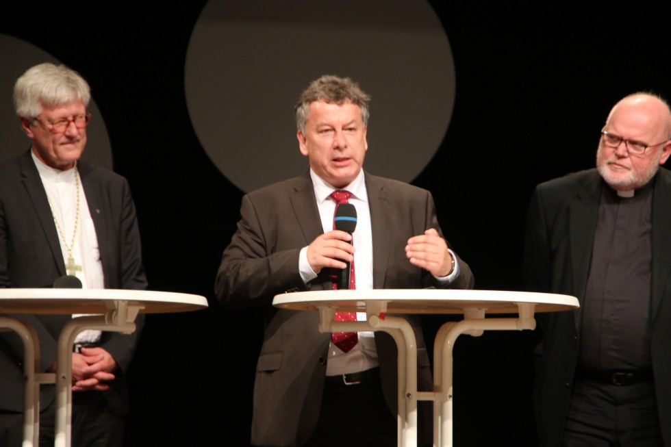 Pastor Thomas Römer (YMCA in Munich, the Lutheran Evangelical Church in Bavaria); Evangelical Bishop Heinrich Bedford-Strohm, president of the Lutheran Confederation in Germany (left); Cardinal Reinhard Marx of Munich, president of the German Roman Catholic Conference of Bishops (right)
